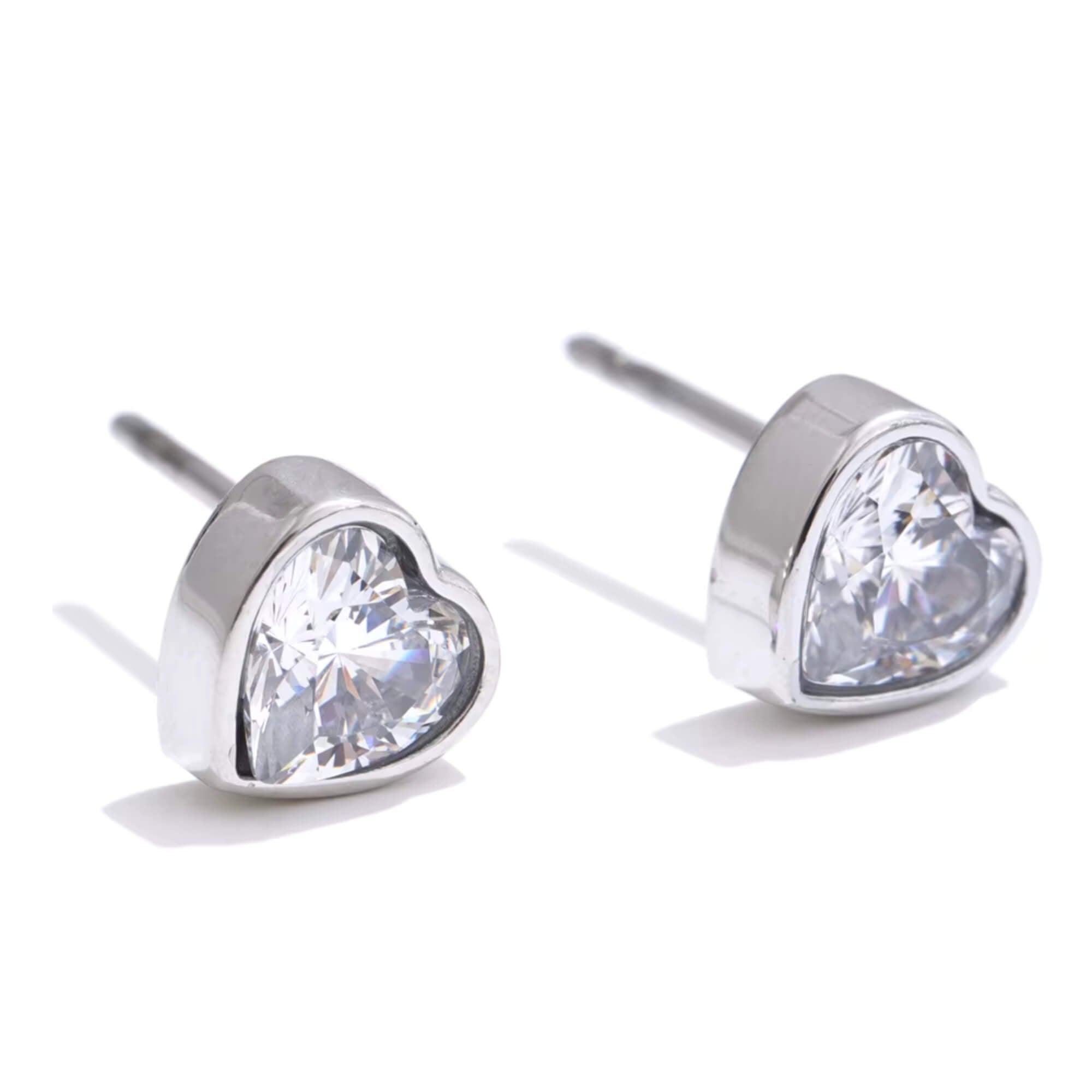 Heart-shaped crystal stud earrings on a white background