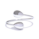 Silver bracelet with two spherical ends on a white background