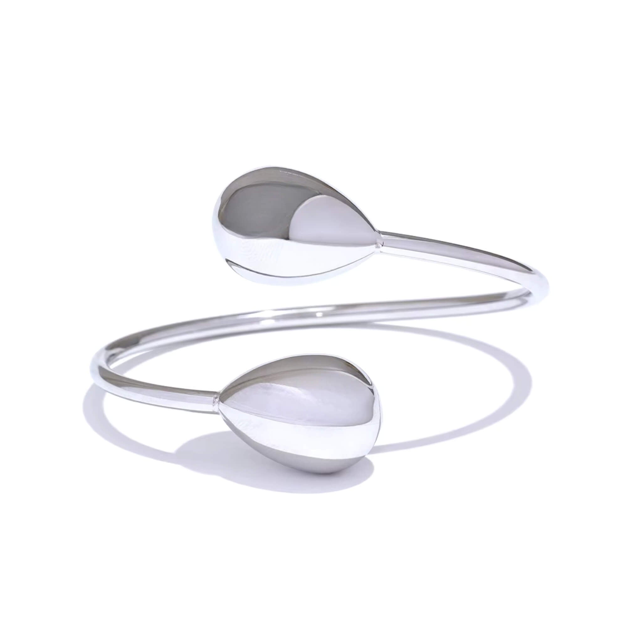 Silver bracelet with two spherical ends on a white background